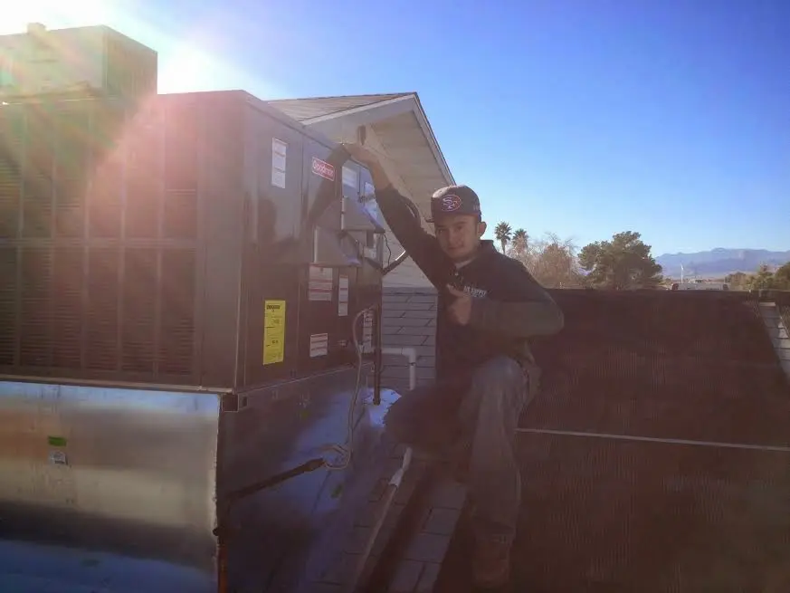 HVAC technician performing HVAC Inspection on a rooftop unit in Cookeville